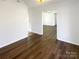 Open-concept living room with hardwood floors leading to other rooms at 14106 Carriage Lake Dr, Charlotte, NC 28273
