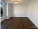 Bright living room with dark hardwood floors and a large window at 14106 Carriage Lake Dr, Charlotte, NC 28273