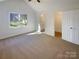 Spacious main bedroom with carpet and window and ensuite bathroom at 14106 Carriage Lake Dr, Charlotte, NC 28273