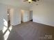 Large main bedroom with carpet and three doors at 14106 Carriage Lake Dr, Charlotte, NC 28273