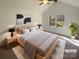 Vaulted main bedroom with large window, a ceiling fan, and neutral decor for a bright and airy feel at 14106 Carriage Lake Dr, Charlotte, NC 28273