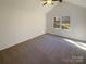 Vaulted main bedroom featuring a large window and neutral tones for a bright and inviting space at 14106 Carriage Lake Dr, Charlotte, NC 28273