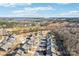 Scenic aerial view of a neighborhood with a lake and industrial buildings in the background under a blue partly cloudy sky at 1426 Whitman Ct, York, SC 29745