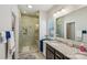 Bathroom with a tiled shower, granite countertop vanity, and a decorative mirror at 1426 Whitman Ct, York, SC 29745