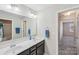Dual sink bathroom vanity and mirrors with contemporary lighting and a doorway view at 1426 Whitman Ct, York, SC 29745
