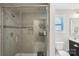 Bright bathroom featuring a tiled shower with glass door and tiled flooring at 1426 Whitman Ct, York, SC 29745