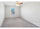 Empty carpeted bedroom with ceiling fan and a view out the single window at 1426 Whitman Ct, York, SC 29745