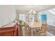 Bright dining room features a chandelier, wood floors, neutral walls, and large windows that let in lots of natural light at 1426 Whitman Ct, York, SC 29745