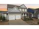 Charming gray two-story home with a two-car garage, inviting front porch, and well-maintained landscaping at 1426 Whitman Ct, York, SC 29745
