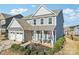 Two-story home featuring a cozy front porch with seating and beautifully landscaped front yard at 1426 Whitman Ct, York, SC 29745