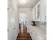 Hallway with white cabinets and countertops, leading into a large, bright kitchen at 1426 Whitman Ct, York, SC 29745