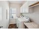 Bright laundry room with washer, dryer, a window, white cabinets, and a countertop at 1426 Whitman Ct, York, SC 29745