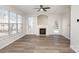 Bright living room with hardwood floors, fireplace, and a ceiling fan at 15425 Coventry Court Ln, Charlotte, NC 28277