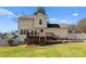 Exterior view of a two-story home showcasing the deck, patio and landscaped backyard at 159 Creekwood Dr, Mooresville, NC 28117