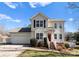 Charming two-story home features a well-maintained lawn and a welcoming front entrance with a red door at 159 Creekwood Dr, Mooresville, NC 28117
