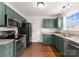 Well-lit kitchen features sleek appliances and granite countertops at 159 Creekwood Dr, Mooresville, NC 28117