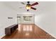 Bright living room features hardwood floors, a ceiling fan, and an adjacent kitchen space at 159 Creekwood Dr, Mooresville, NC 28117