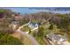 Aerial view of a modern farmhouse with a lush lawn and mature landscaping at 16112 Terry Ln, Huntersville, NC 28078