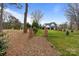 Beautiful backyard featuring a well-maintained lawn and modern home exterior with black trim accents at 16112 Terry Ln, Huntersville, NC 28078