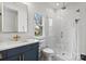 Stylish bathroom with a glass-enclosed shower, designer vanity, and marble tile at 16112 Terry Ln, Huntersville, NC 28078