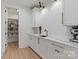 Clean butler's pantry featuring white cabinets, counter, and shelving for pantry items at 16112 Terry Ln, Huntersville, NC 28078