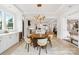 Bright dining area showcasing modern chandelier, a round table, and an open view to the kitchen at 16112 Terry Ln, Huntersville, NC 28078