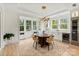 Sunlit dining area with beverage center, comfortable seating, and large windows with treed view at 16112 Terry Ln, Huntersville, NC 28078