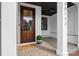 Inviting front porch featuring a wood door, brick flooring, and a 'welcome' mat at 16112 Terry Ln, Huntersville, NC 28078