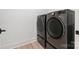 Convenient laundry room featuring side-by-side washer and dryer units in a neutral color scheme at 16112 Terry Ln, Huntersville, NC 28078