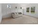 Bright living room with modern paneling, several windows, and a comfortable couch at 16112 Terry Ln, Huntersville, NC 28078