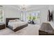 Bright main bedroom featuring a modern light fixture and a dedicated exercise space at 16112 Terry Ln, Huntersville, NC 28078