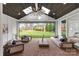 Covered outdoor patio with brick flooring, comfortable seating, ceiling fan, and backyard views at 16112 Terry Ln, Huntersville, NC 28078