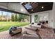 Inviting covered patio with brick flooring, ceiling fan, comfortable seating, and open backyard view at 16112 Terry Ln, Huntersville, NC 28078