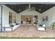 Inviting covered patio features comfortable seating, a ceiling fan, and seamless indoor-outdoor flow at 16112 Terry Ln, Huntersville, NC 28078