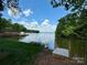 Picturesque waterfront property featuring lush greenery and a private dock for serene lakeside living at 16112 Terry Ln, Huntersville, NC 28078