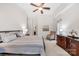 Relaxing bedroom featuring a ceiling fan and tasteful furnishings at 16614 Amberside E Rd, Cornelius, NC 28031