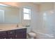 Bright bathroom with a tub, toilet, and vanity with dark brown cabinets and white countertops at 173 Glastonbury Dr, Mooresville, NC 28115