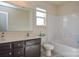 Well-lit bathroom featuring a double vanity, toilet, and a shower-tub combination at 173 Glastonbury Dr, Mooresville, NC 28115