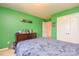 Bedroom featuring bright green walls, a bed, a window, and closet space at 173 Glastonbury Dr, Mooresville, NC 28115