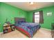 Vibrant green bedroom with a comfortable bed and a window, creating a cozy and inviting space at 173 Glastonbury Dr, Mooresville, NC 28115