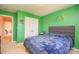 Bedroom featuring bright green walls, a bed, and closet space; decorated with fun wall art at 173 Glastonbury Dr, Mooresville, NC 28115