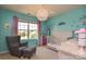 A bedroom decorated with aqua walls, a whimsical chandelier, and a window with a view at 173 Glastonbury Dr, Mooresville, NC 28115