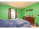 Bedroom with green walls, featuring a dresser and window, offering a quiet retreat at 173 Glastonbury Dr, Mooresville, NC 28115