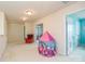 Spacious bonus room featuring neutral walls, carpet flooring, and a cozy red accent chair, with a playroom tent at 173 Glastonbury Dr, Mooresville, NC 28115