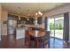 Inviting dining area with dark wood table and chairs adjacent to a kitchen with stainless steel appliances at 173 Glastonbury Dr, Mooresville, NC 28115