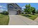 Charming two-story home featuring a two-car garage and stone-accented entryway on a lush lawn at 173 Glastonbury Dr, Mooresville, NC 28115