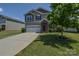 Traditional two-story home with a stone-accented entrance and attached two-car garage nestled on a green lot at 173 Glastonbury Dr, Mooresville, NC 28115