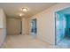 Upstairs hallway featuring two doors to rooms, each with neutral colored walls and carpet at 173 Glastonbury Dr, Mooresville, NC 28115
