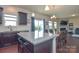 Open concept kitchen with granite island, dining area, and living room in the background at 173 Glastonbury Dr, Mooresville, NC 28115