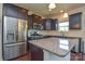 Modern kitchen featuring stainless steel appliances, granite countertops, and dark wood cabinetry at 173 Glastonbury Dr, Mooresville, NC 28115